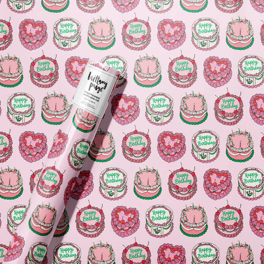 roll of wrapping paper with a continous pattern of birthdy cakes decorated in a vintage style