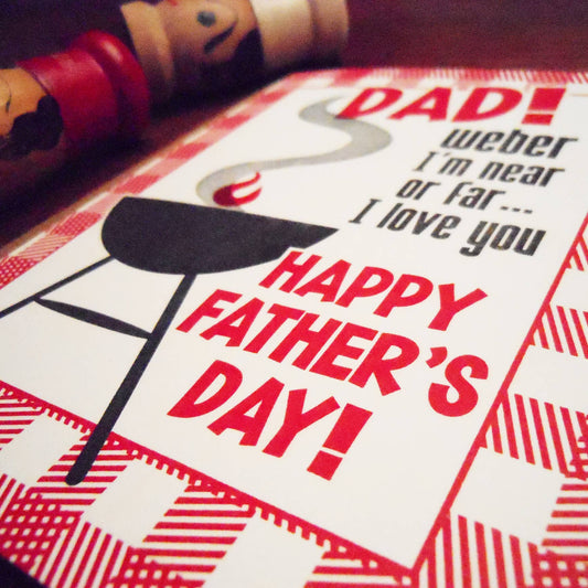Father's Day card with barbecue graphic and text, featuring a red and white design.