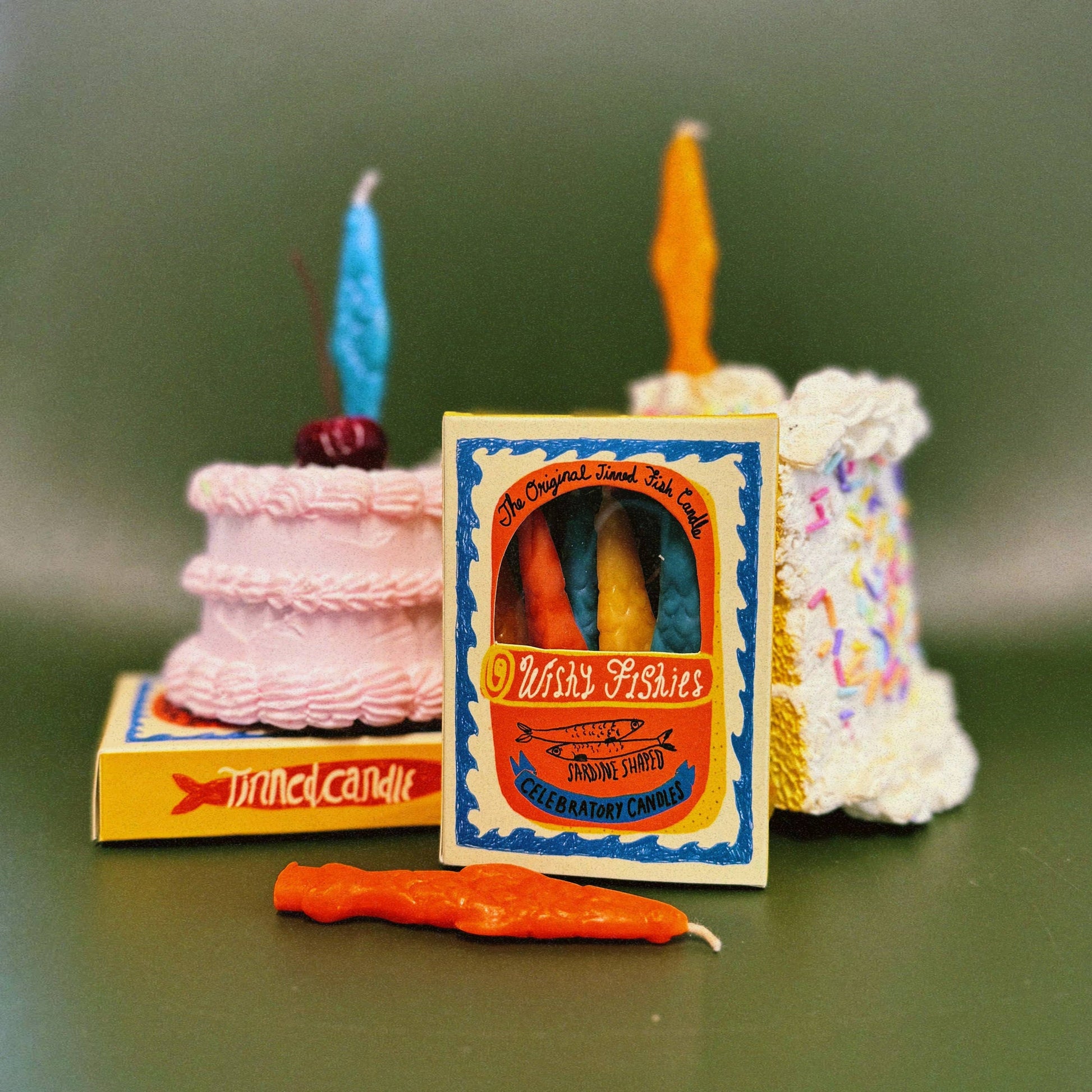 A box of 8 individual sardine shaped birthday candles