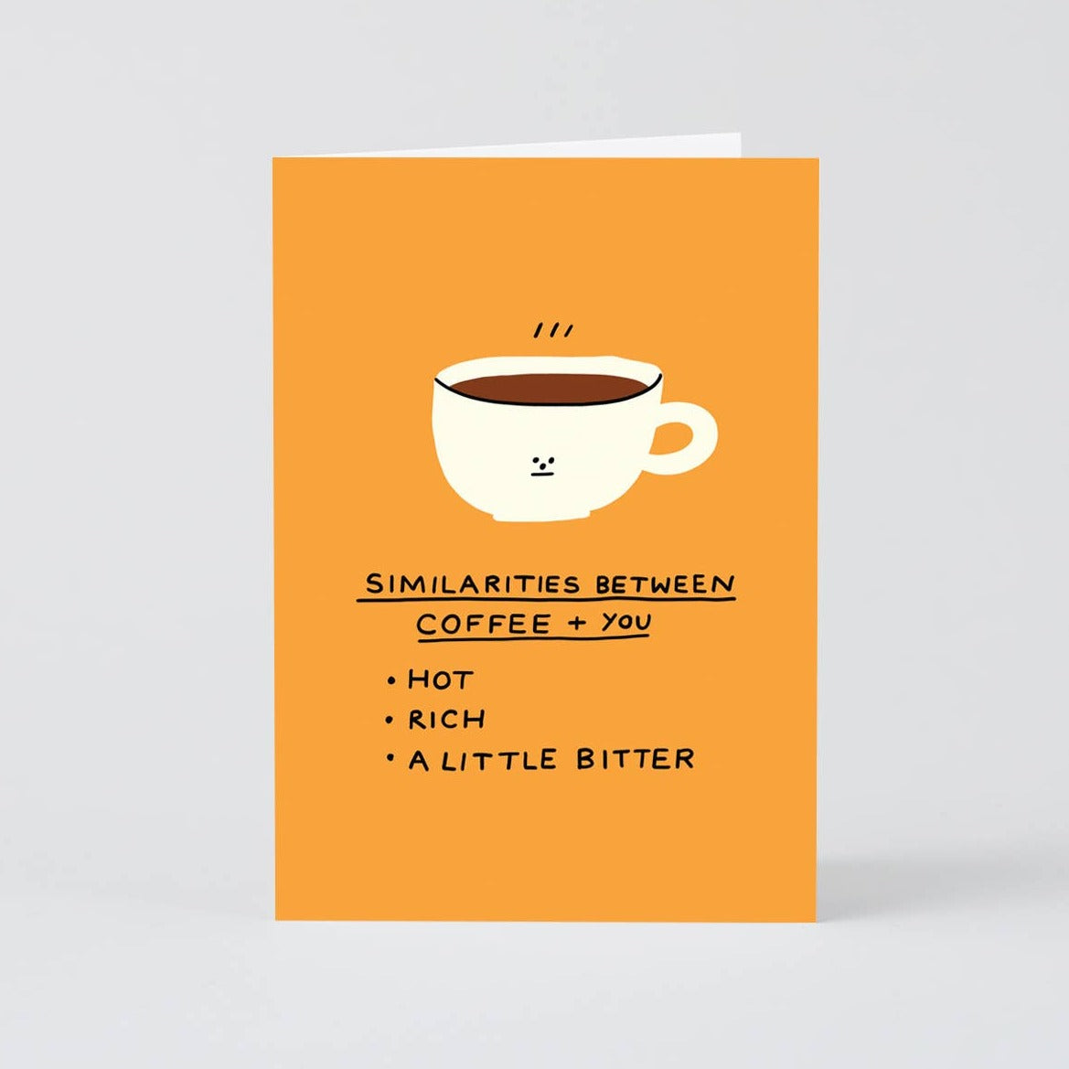 Greeting card with a coffee mug on it. Text below reads "Similarities between coffee + you -- hot, rich, a little bitter" 