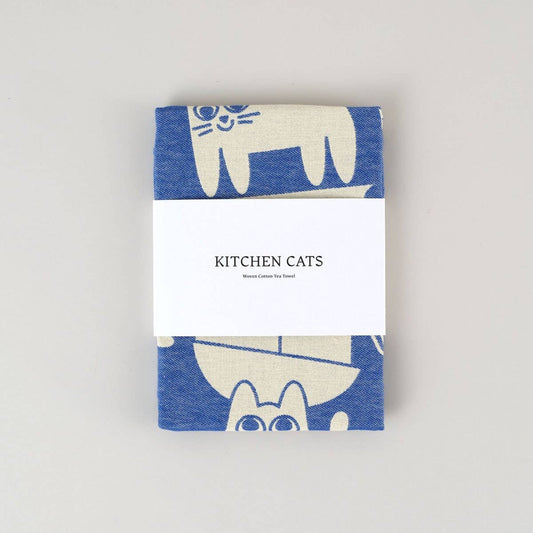 blue and white "kitchen cats" tea towel wrapped in paper band packaging 