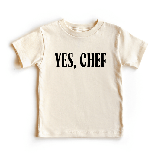 Cream colored kid's shirt with black text that says "yes, chef' 