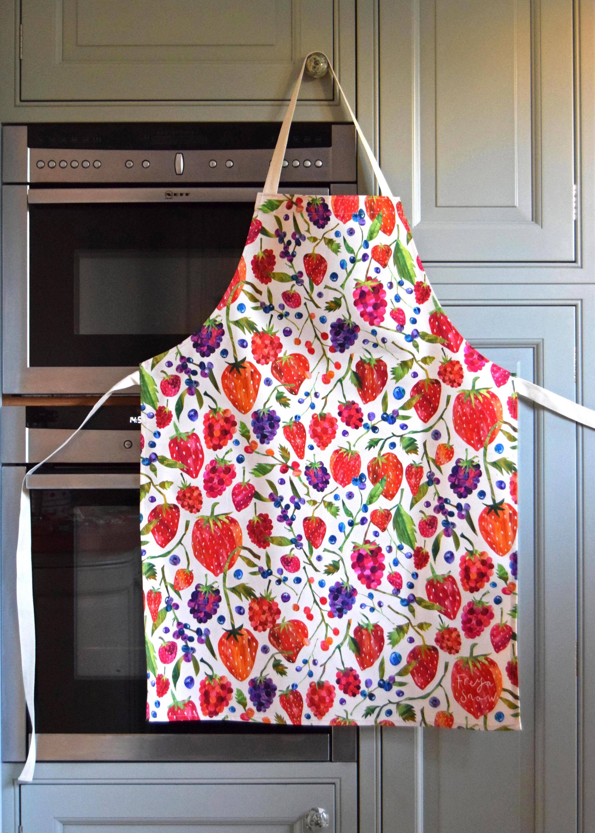 White apron designed with different berries