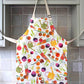 Children's apron with different garden vegetables and watering cans on it 
