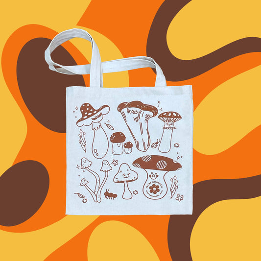 natural canvas tote bag with a mushroom design printed on it in brown ink. Background is a funky, 70s inspired pattern in brown, yellow and orange 