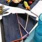 dark denim napkin set of 4 with different colored embroidered edges 