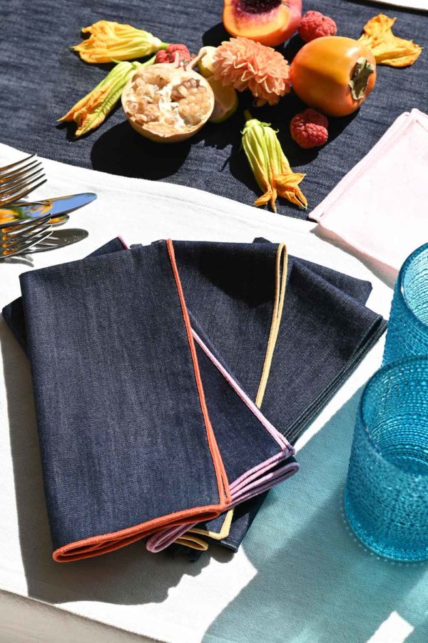 dark denim napkin set of 4 with different colored embroidered edges 