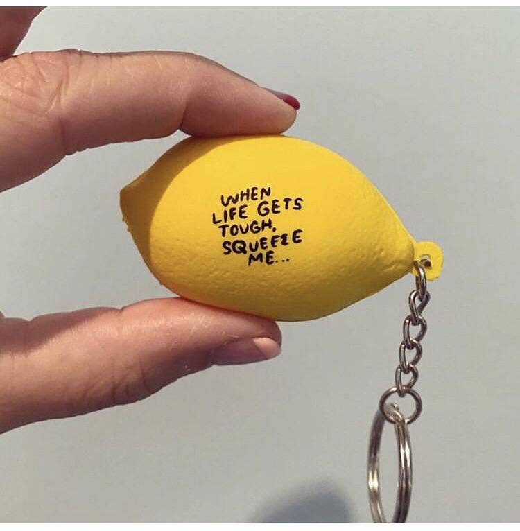 Lemon stress ball keychain -- text on it reads "When life gets tough, squeeze me..." 