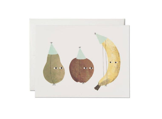Greeting card with a pear, apple and banana wearing birthday hats 