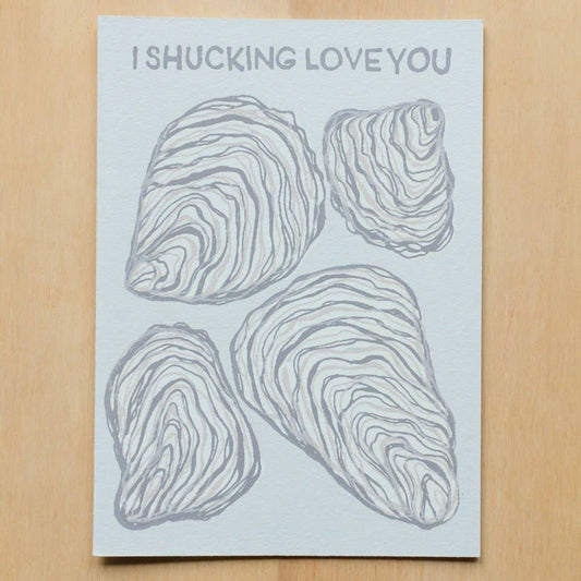 Greeting card that reads "I shucking love you" and has four oysters on it. 