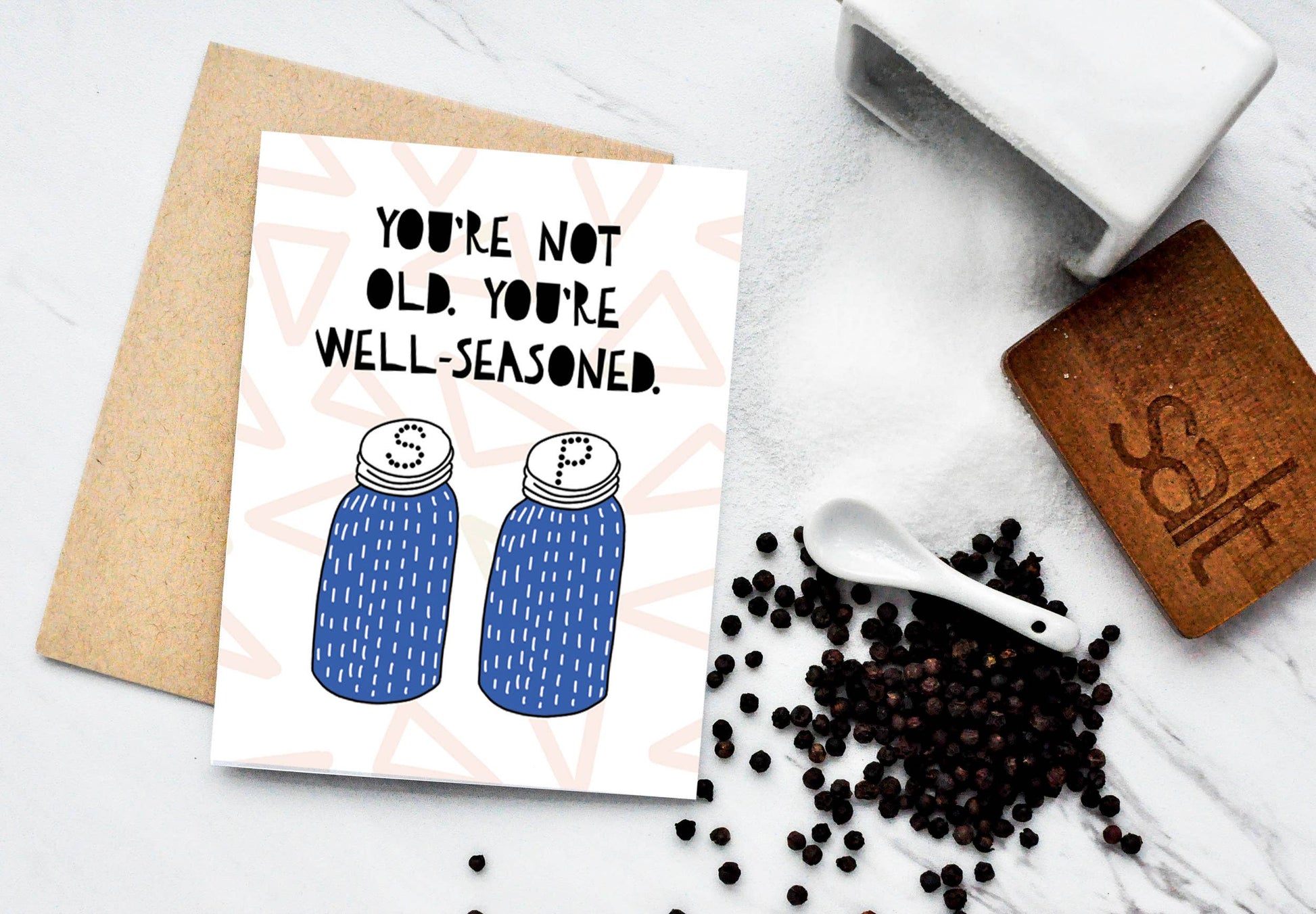 Greeting card with salt and pepper shakers on it that reads "You're not old, You're well-seasoned" 