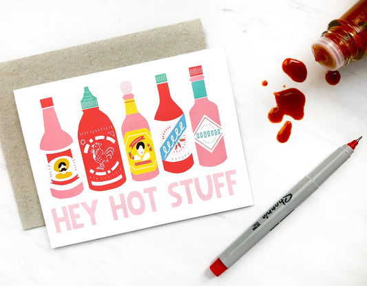 Greeting card that has 5 different hot sauce bottles on it and reads "Hey Hot Stuff" 