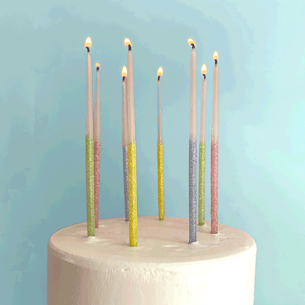 glitter beeswax birthday candles in green, pink, purple and yellow 