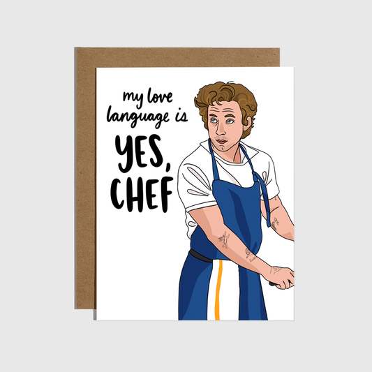 Greeting card with illustration of TV dreamboat Jeremy Allen White in his blue apron (bar towel hangin from his waist) lookin out from under his floppy, perfectly tousled hair with the text "my love language is YES, CHEF" on a plain white background.