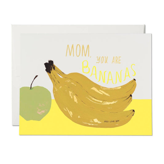 Greeting card with a green apple and bunch of bananas on it. Text reads "Mom, you are bananas" 