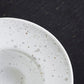 close-up of speckled white egg cup/saucer 