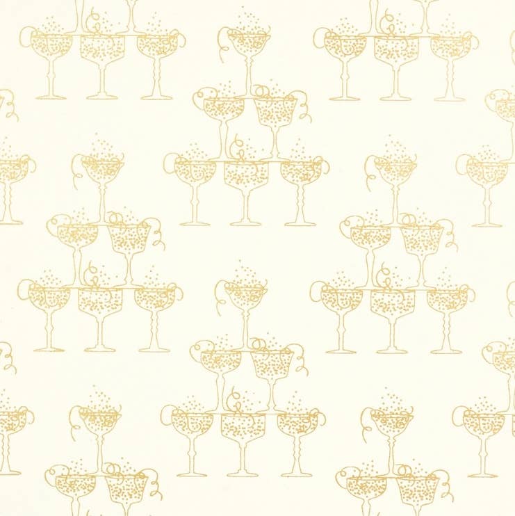 Gold foil gift wrap with champagne couples bubbling over with liquid. Cream and gold paper.