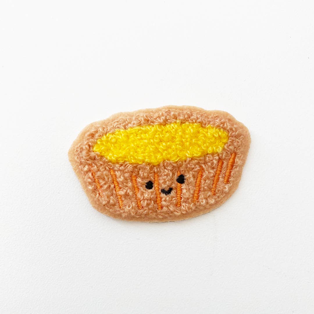 Chenille patch in the shape of an egg tart.