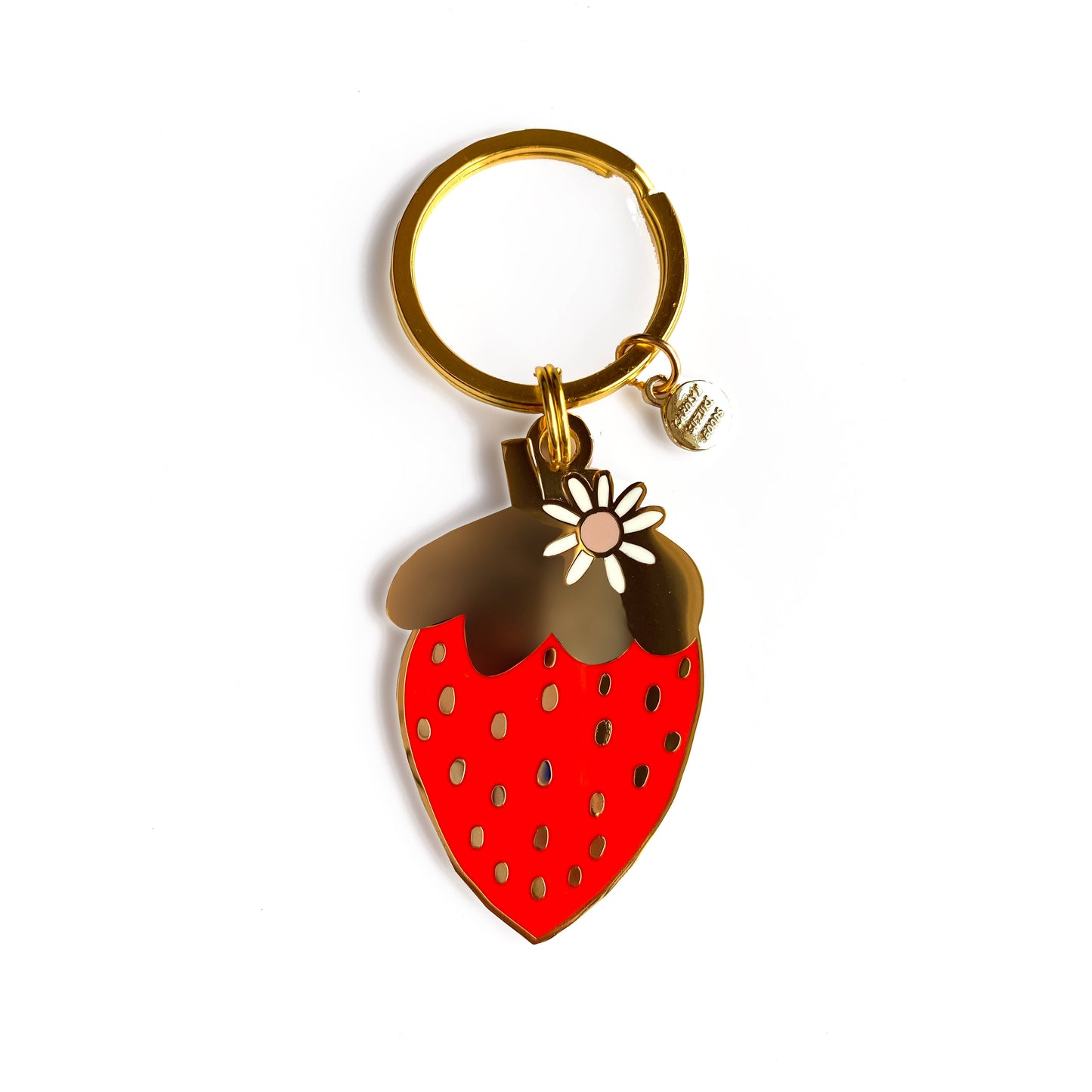 Gold, hard enamel strawberry keychain. Mostly gold with the body of the strawberry being red. There is a white daisy in the upper right next to the stem. 