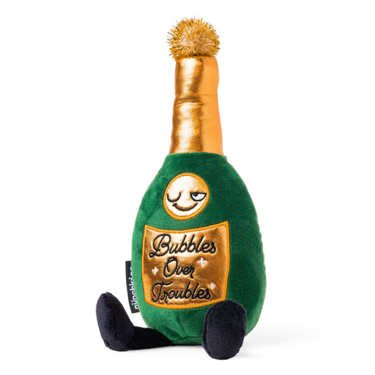 Champagne bottle plush that reads "Bubbles Over Troubles" 