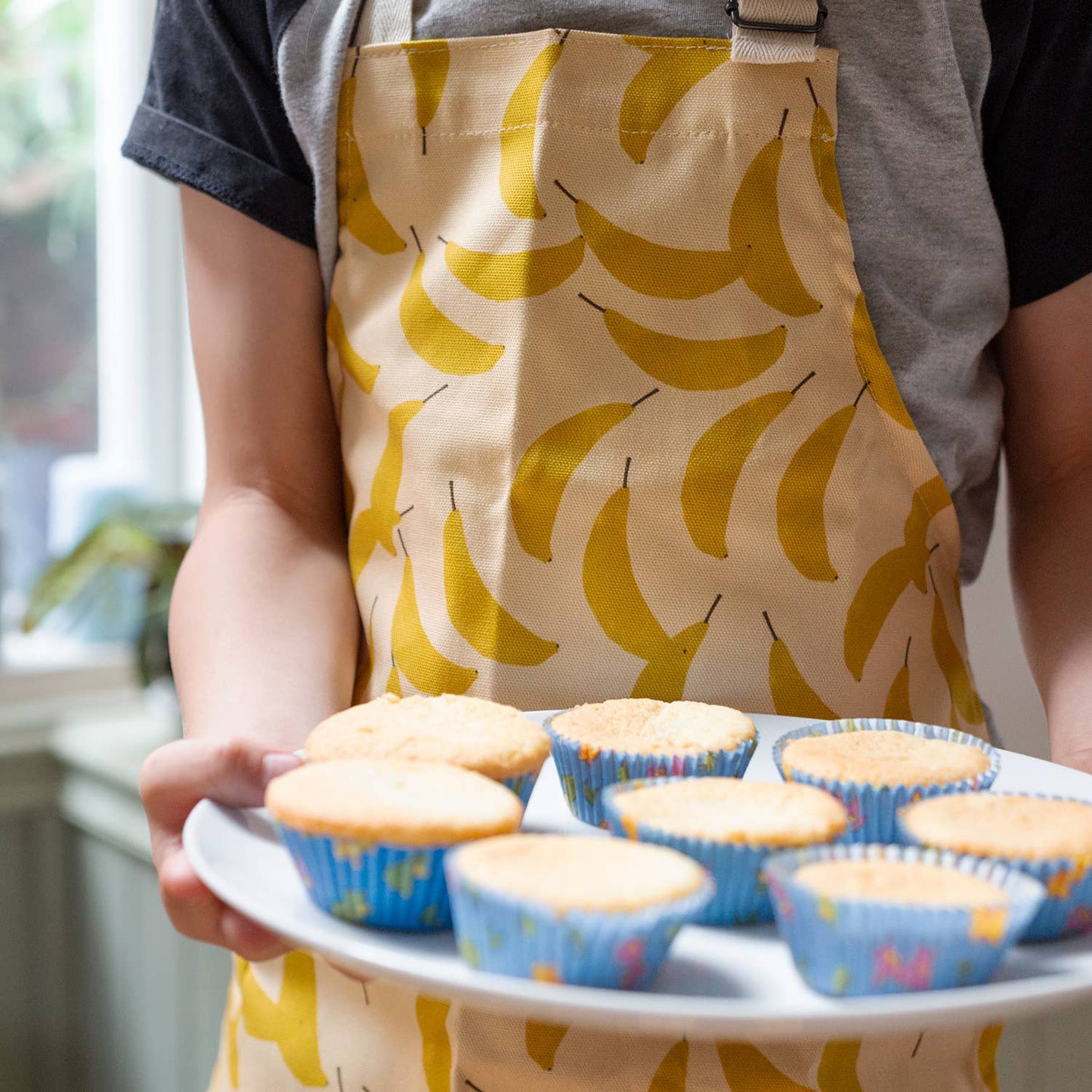 Children size apron with banana print all over