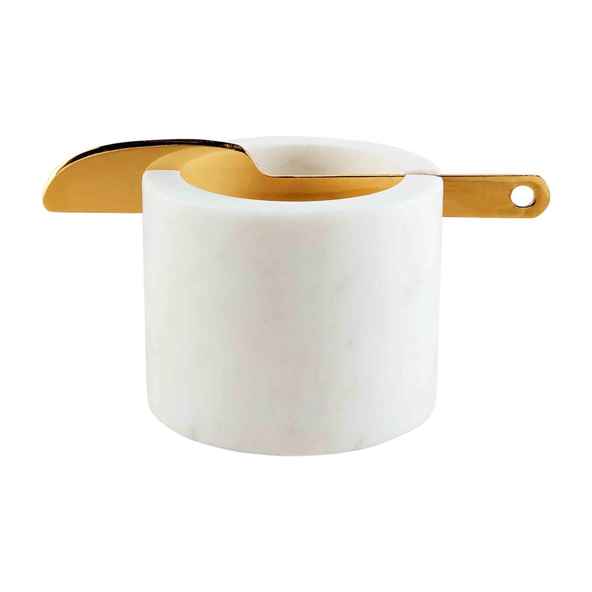 White marble dip cup with a brass spreading knife