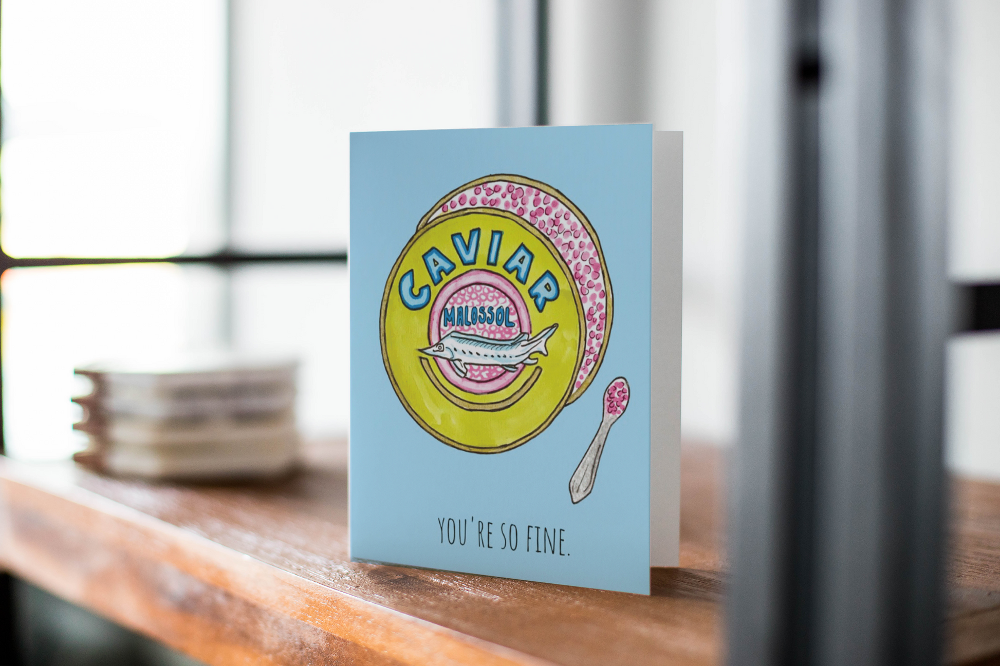 Greeting card featuring illustration of a cute neon caviar tin labeled "Caviar... Malossol" with caviar spoon on side. Additional text on card reads "You're So Fine." on the bottom.