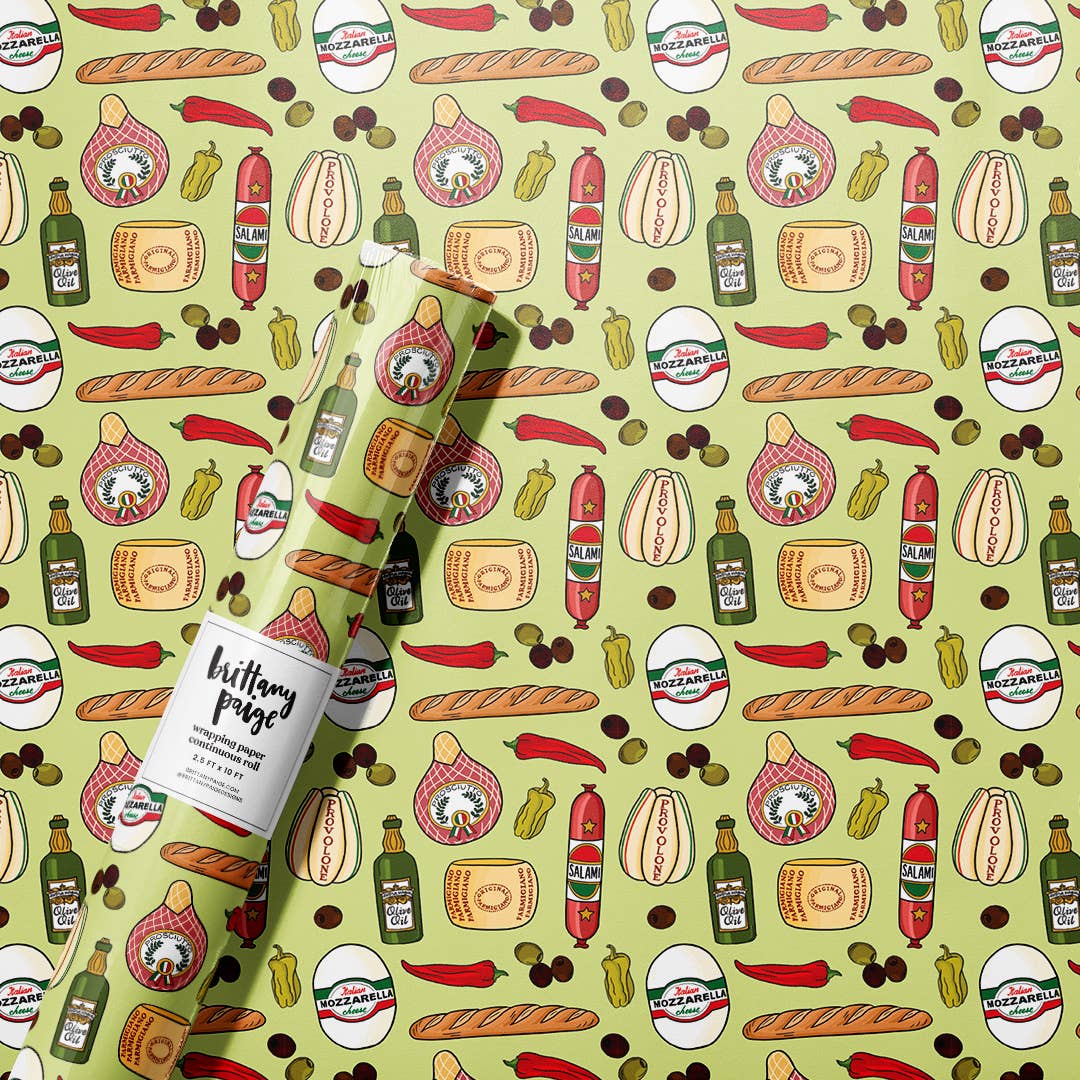 Gift wrap roll with different Italian meats and cheeses on it along with olives, peppers, baguettes and olive oil