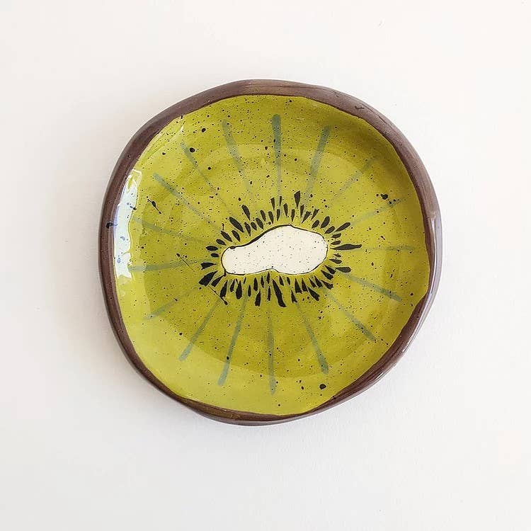 Small green kiwi plate, View is as if kiwi is cut in half 