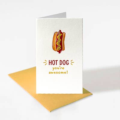 Mini enclosure card with a hot dog that has mustard squiggle and relish on it. The letterpressed card reads "HOT DOG You're Awesome!" Mustard colored envelope.
