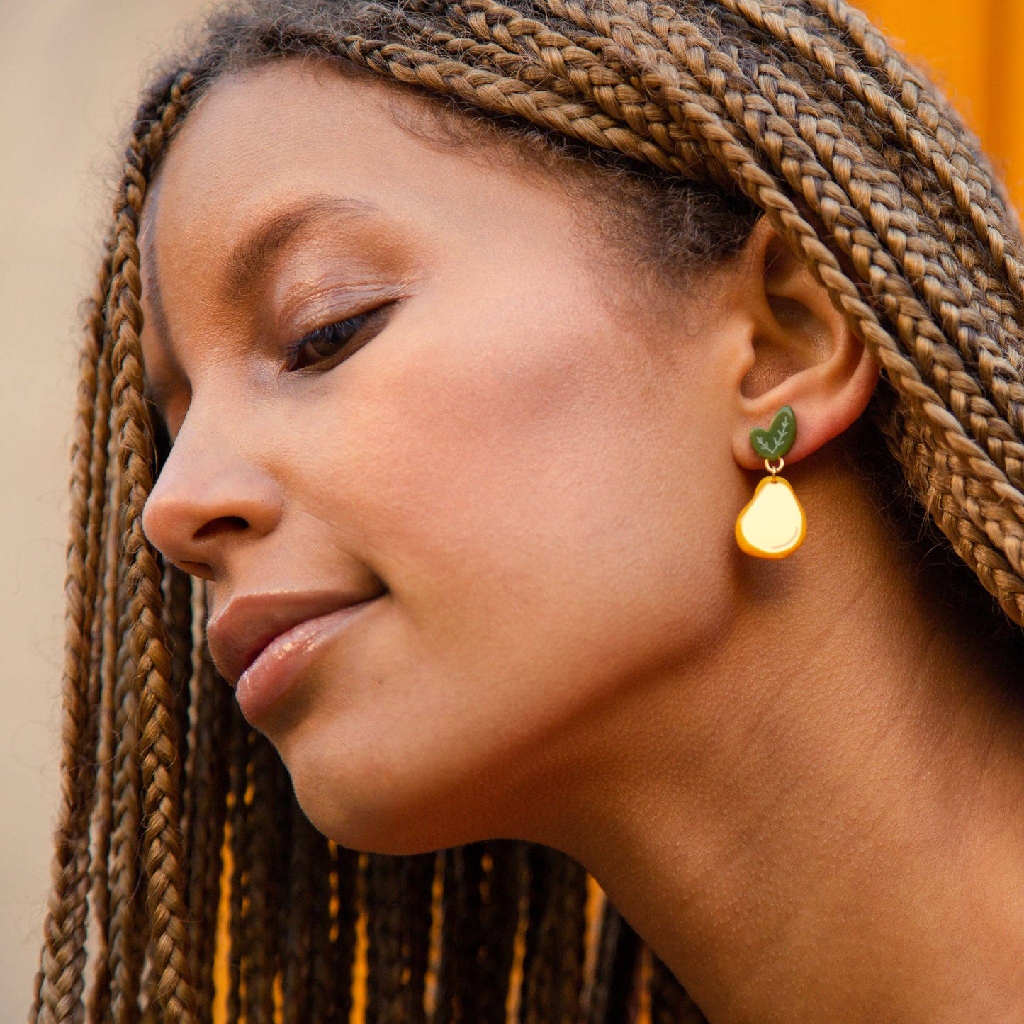 gold pear earrings worn on model for size 