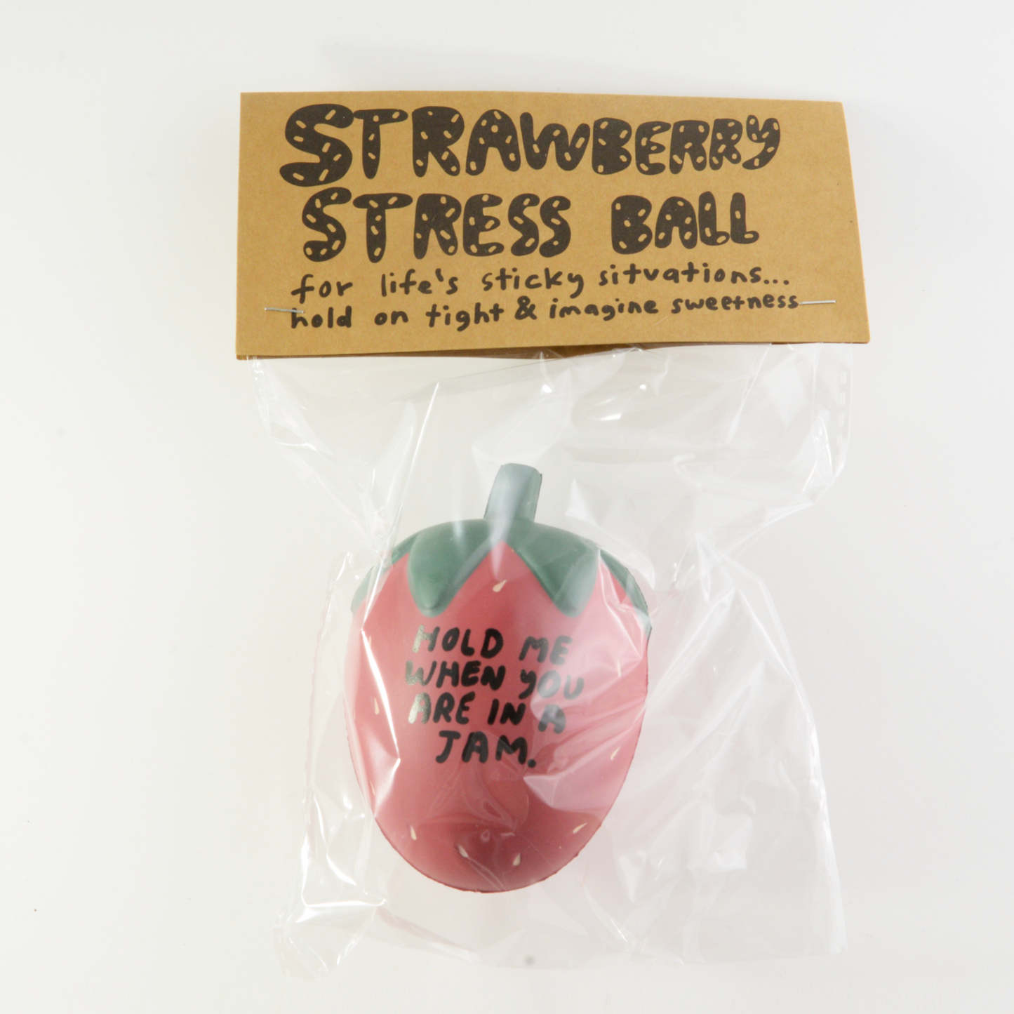 Stress ball that looks like a strawberry and reads "Hold me when you're in a jam"