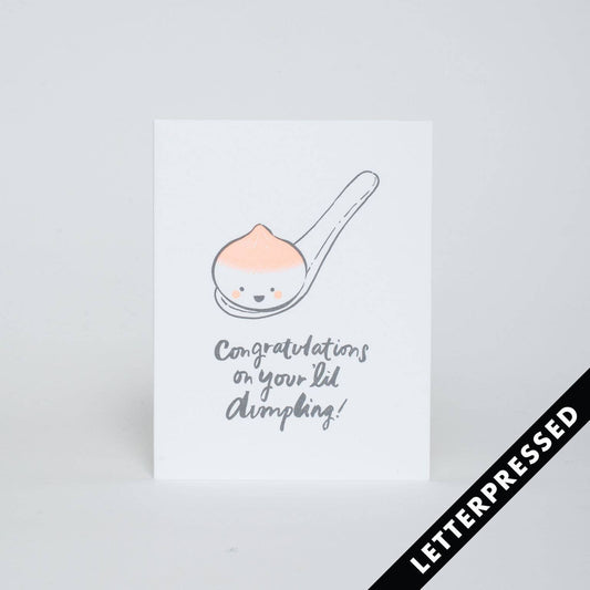 Greeting card that reads "Congratulations on your lil dumpling!" and has an image of a soup dumpling on a spoon