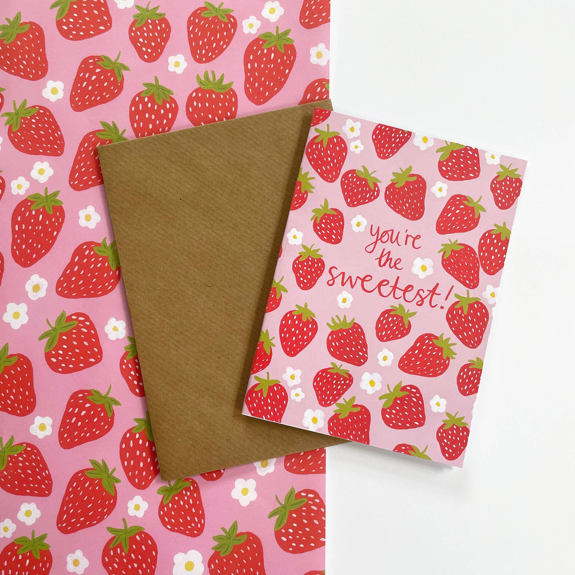 Strawberry wrapping paper + matching card that reads "You're the Sweetest"