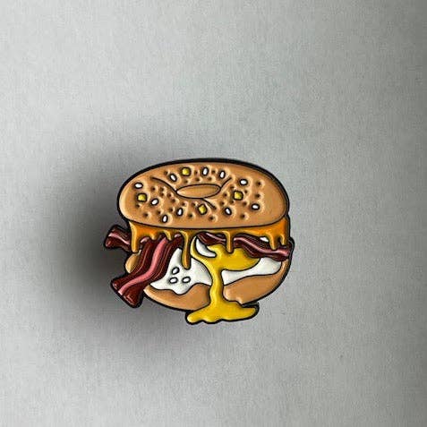 Bagel sandwich lapel pin with bacon egg and cheese.