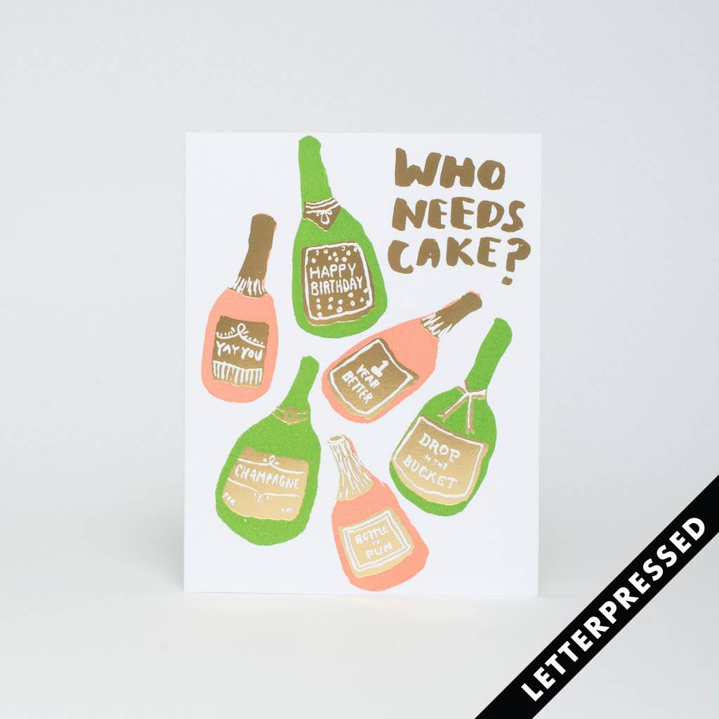 Greeting card with six champagne bottles whose labels each say different things. In the top right corner it reads "Who needs cake?"