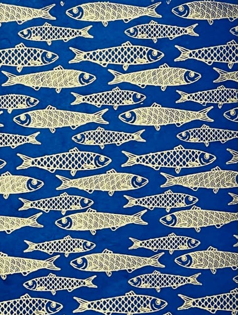 Single sheet of dark blue/indigo gift wrap with gold foil fishes as the design 