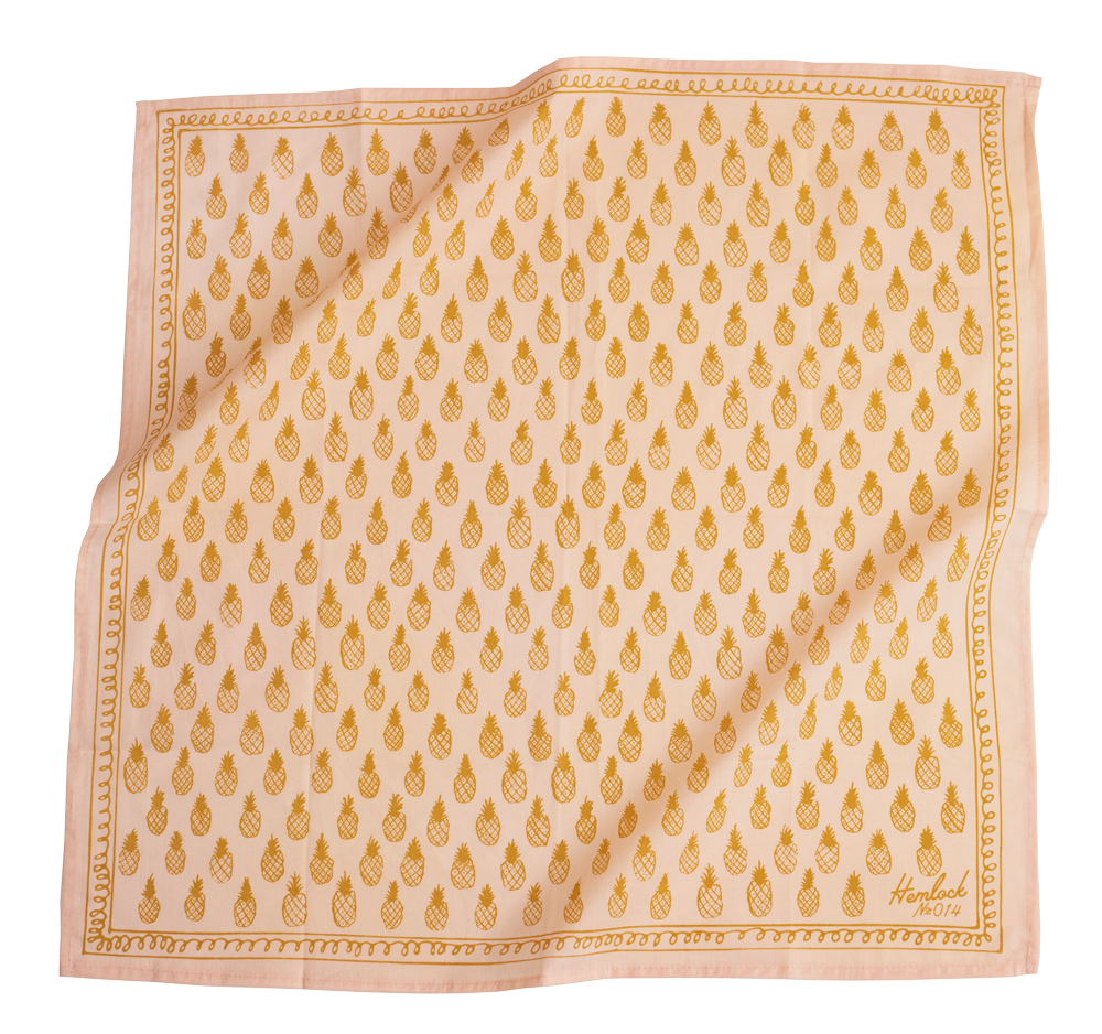 Light pink bandana with golden pineapples on it