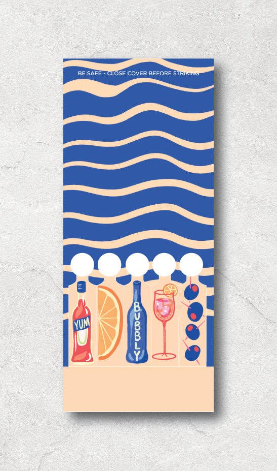 Spritz matchbook open to reaveal that the matches are in the shape of Campari, orange wedge, bubbles, spritz in a glass and olives on a pick.