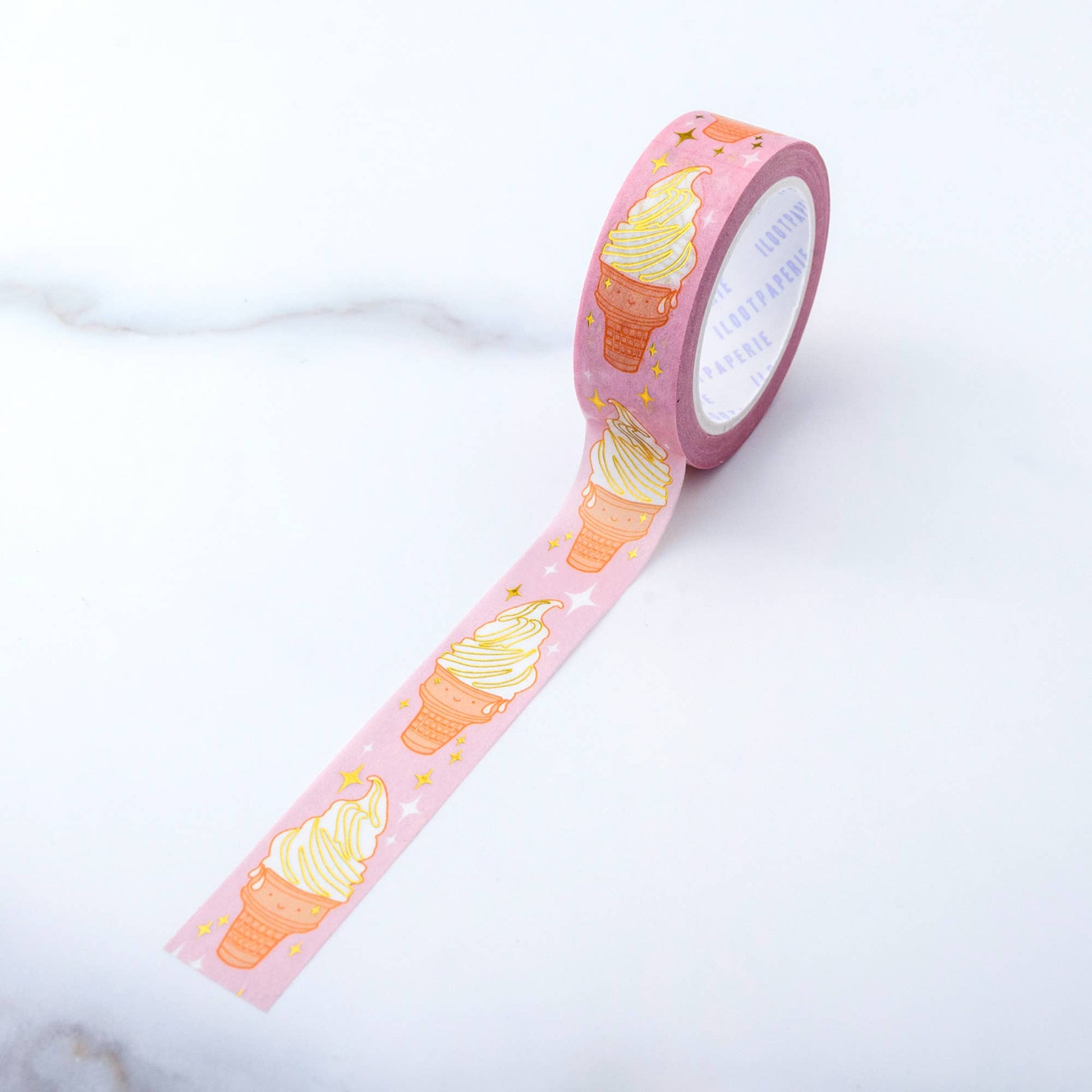 Washi tape with a vanilla soft serve swirl on a cake cone with a happy face. Gold foiled motifs.