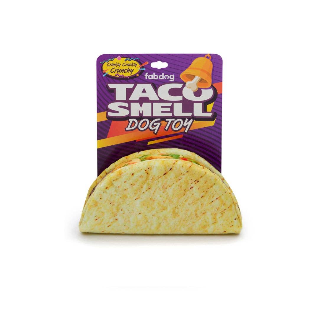 Dog toy shaped like a taco in purple and yellow packaging.