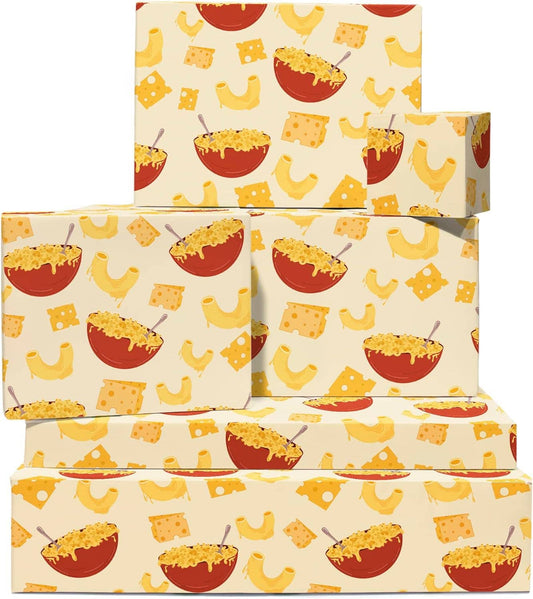 Multiple boxes wrapped in mac and cheese designed wrapping paper -- design includes bowl of mac and cheese, macaroni pasta, and cheeses all over 