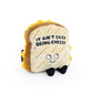 Grilled cheese plush toy that reads "It ain't easy being cheesy" 
