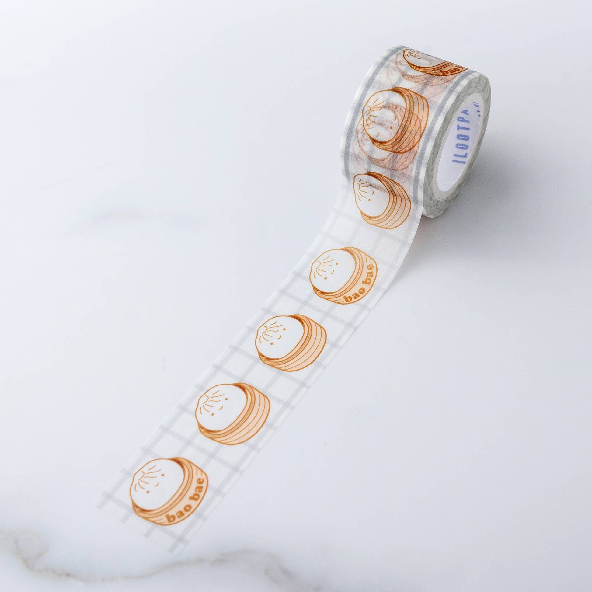 Washi Tape roll with repeat pattern of single bao with a sweet smile, sitting in a steamer. Every third steamer has the words "bao bae" on the side .
