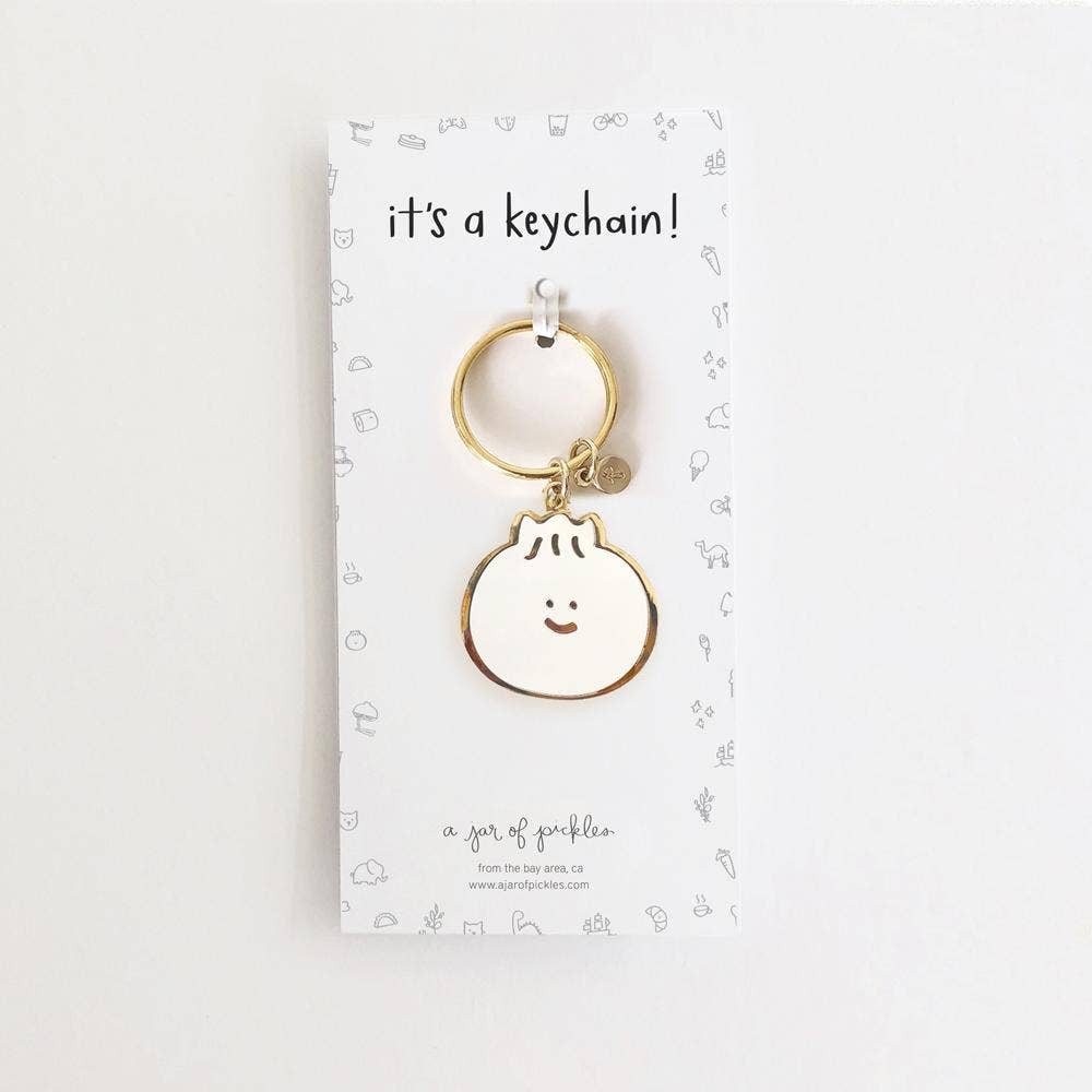 Bao dumpling enamel keychain with smiley face.