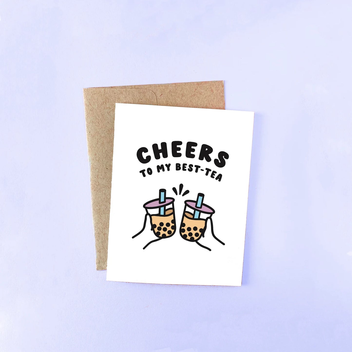 White greeting card that reads in bold, black font "Cheers to my best-tea" The image shows to hands, each holding boba cups. Comes with a brown envelope. 