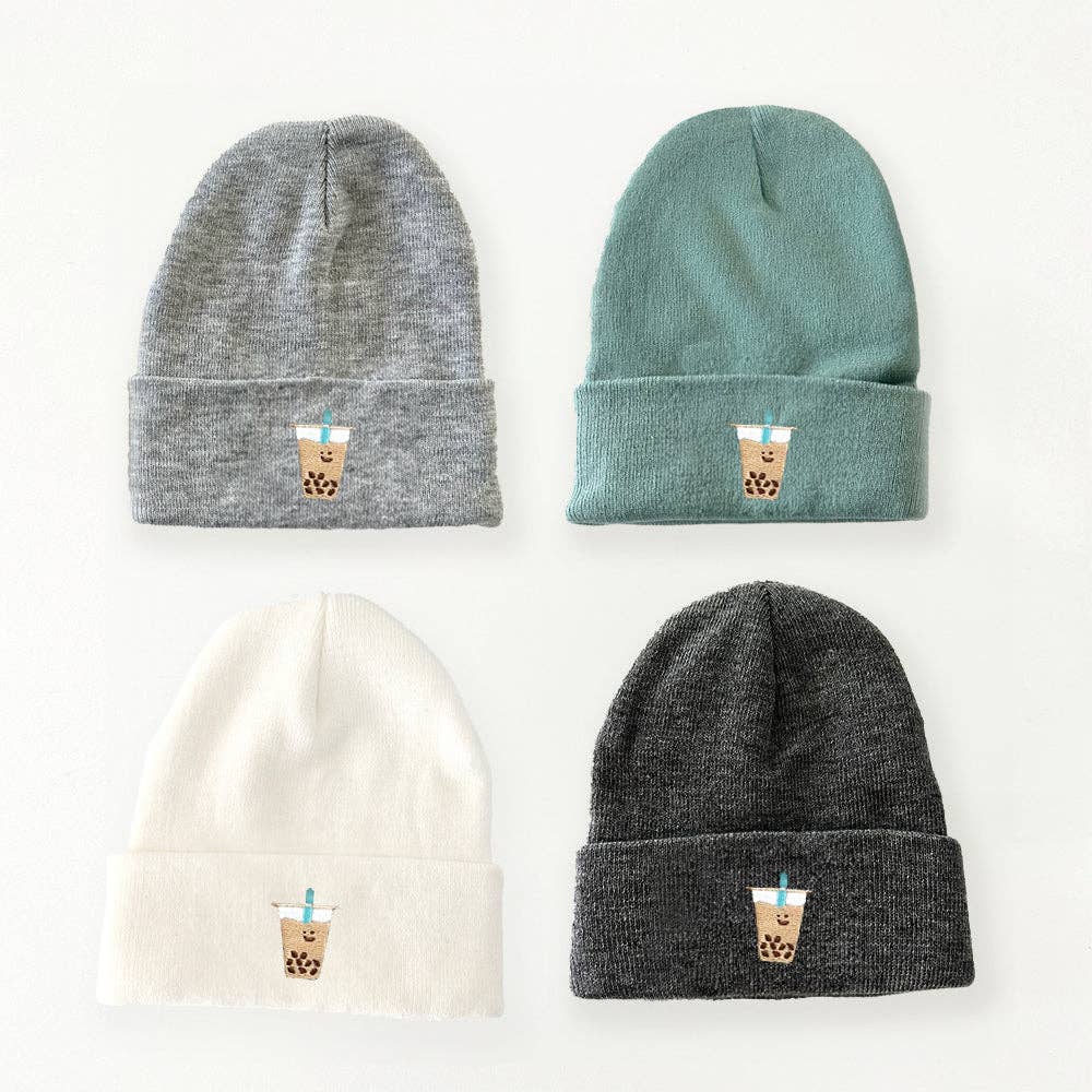 4 different colored boba beanies. Each featuring one boba cup each with a teal straw. Beanies are grey, teal, white and charcoal.