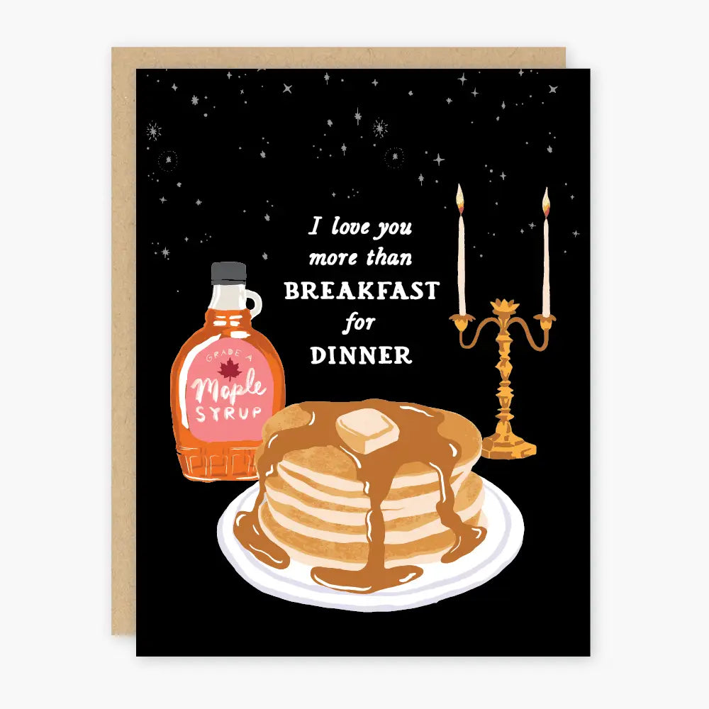 Greeting card that reads "I love you more than breakfast for dinner" and has images of maple syrup, a stack of pancakes and a candelabra