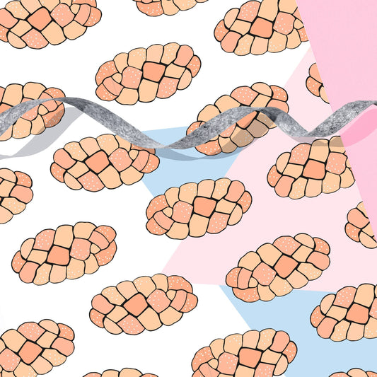 Challah wrapping paper patterned with blue and pink pastel shapes in the background.