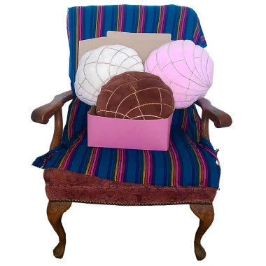 Pan dulce plush pillow cushions in white, pink and brown shown in pink bakery box